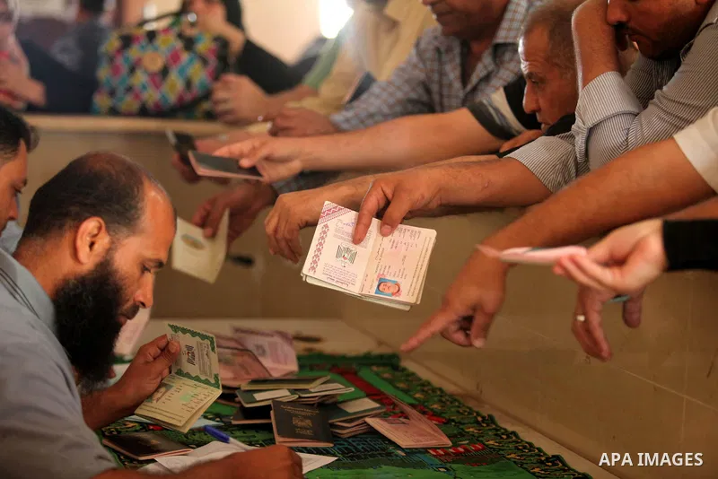 Palestinians gather at the Rafah border crossing in the southern Gaza Strip, as they await permission to enter Egypt on June 14, 2015. Egypt is due to reopen its Rafah border crossing with Gaza for three days. The Rafah...