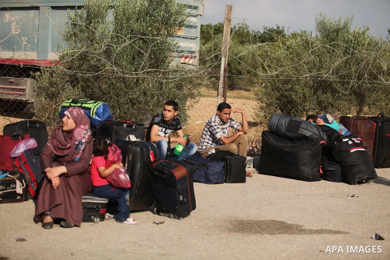 Palestinians gather at the Rafah border crossing in the southern Gaza Strip, as they await permission to enter Egypt on June 14, 2015. Egypt is due to reopen its Rafah border crossing with Gaza for three days. The Rafah...