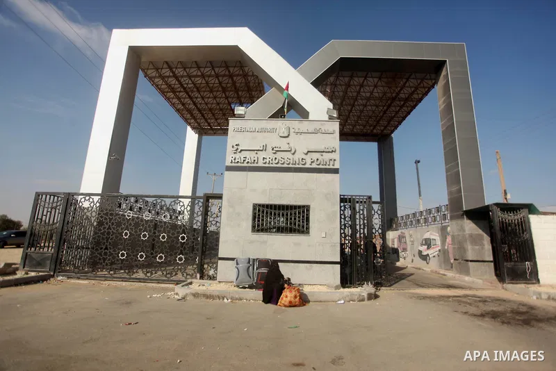 Palestinians gather at the Rafah border crossing in the southern Gaza Strip, as they await permission to enter Egypt on June 14, 2015. Egypt is due to reopen its Rafah border crossing with Gaza for three days. The Rafah...