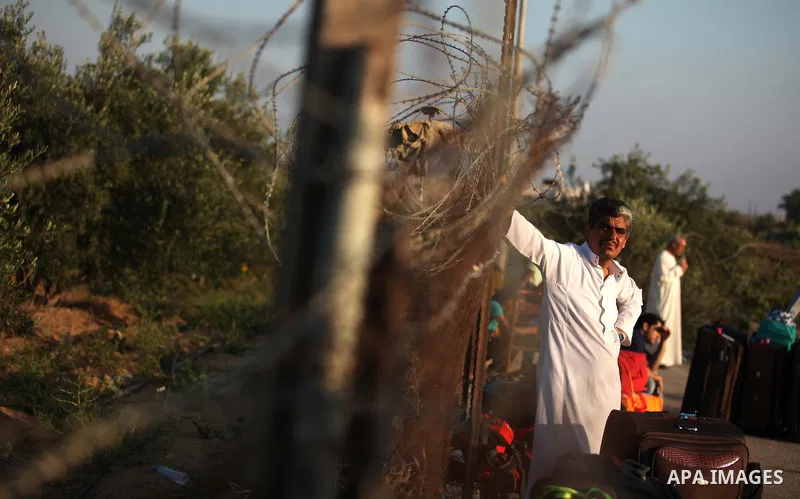Palestinians gather at the Rafah border crossing in the southern Gaza Strip, as they await permission to enter Egypt on June 14, 2015. Egypt is due to reopen its Rafah border crossing with Gaza for three days. The Rafah...