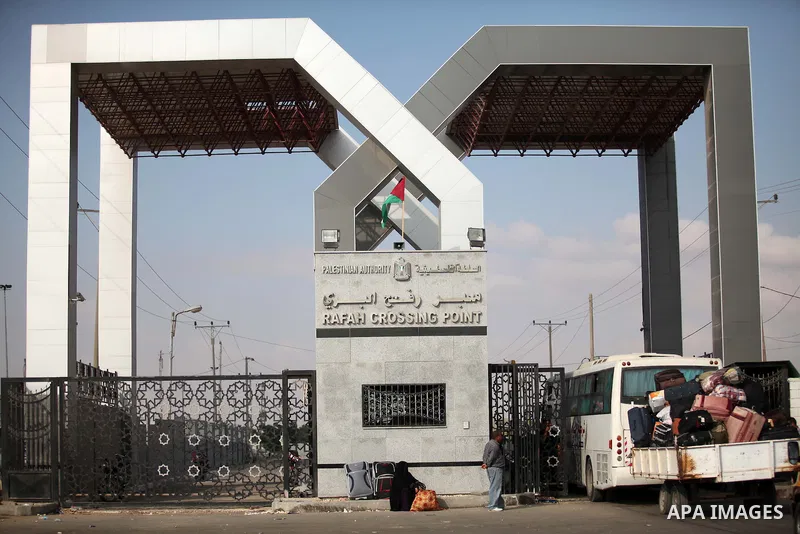 Palestinians gather at the Rafah border crossing in the southern Gaza Strip, as they await permission to enter Egypt on June 14, 2015. Egypt is due to reopen its Rafah border crossing with Gaza for three days. The Rafah...