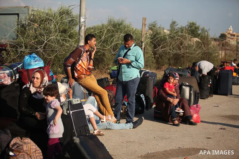 Palestinians gather at the Rafah border crossing in the southern Gaza Strip, as they await permission to enter Egypt on June 14, 2015. Egypt is due to reopen its Rafah border crossing with Gaza for three days. The Rafah...