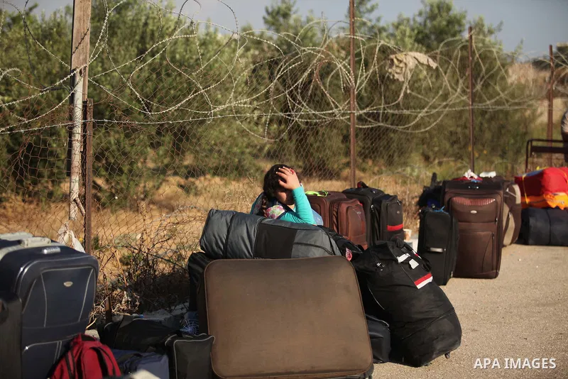 Palestinians gather at the Rafah border crossing in the southern Gaza Strip, as they await permission to enter Egypt on June 14, 2015. Egypt is due to reopen its Rafah border crossing with Gaza for three days. The Rafah...