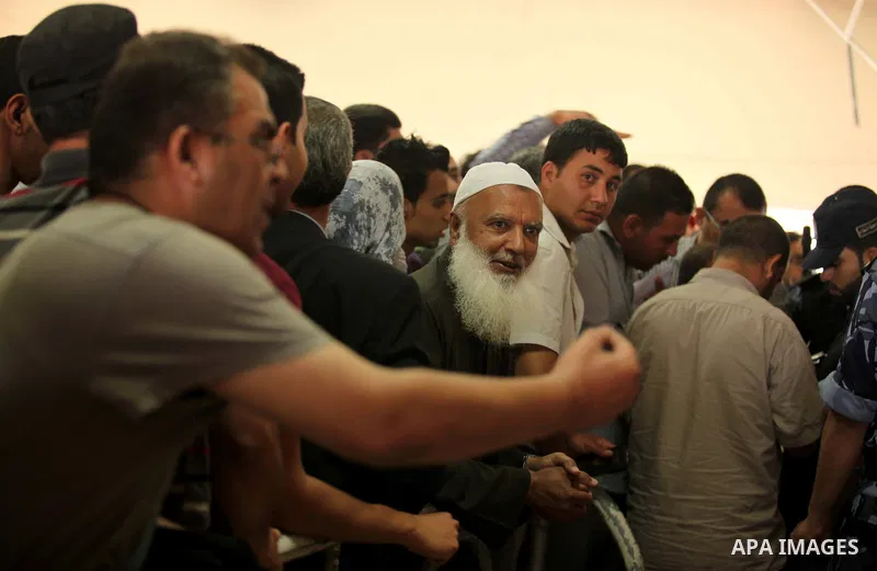 Palestinians gather at the Rafah border crossing in the southern Gaza Strip, as they await permission to enter Egypt on June 14, 2015. Egypt is due to reopen its Rafah border crossing with Gaza for three days. The Rafah...