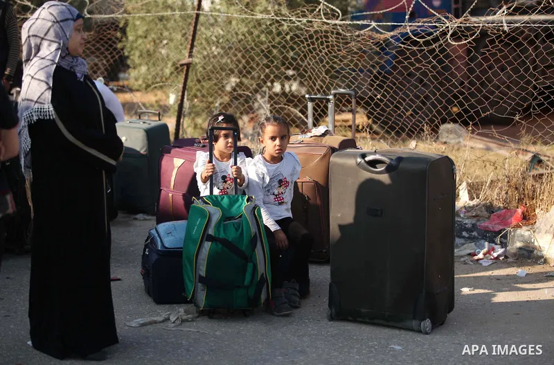 Palestinians gather at the Rafah border crossing in the southern Gaza Strip, as they await permission to enter Egypt on June 14, 2015. Egypt is due to reopen its Rafah border crossing with Gaza for three days. The Rafah...