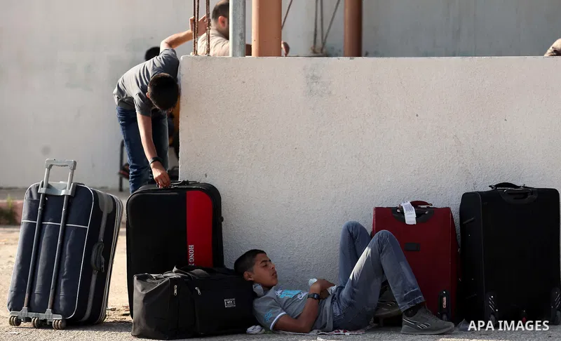 Palestinians gather at the Rafah border crossing in the southern Gaza Strip, as they await permission to enter Egypt on June 14, 2015. Egypt is due to reopen its Rafah border crossing with Gaza for three days. The Rafah...