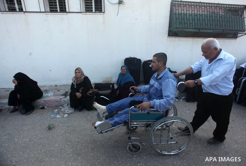 Palestinians gather at the Rafah border crossing in the southern Gaza Strip, as they await permission to enter Egypt on June 14, 2015. Egypt is due to reopen its Rafah border crossing with Gaza for three days. The Rafah...