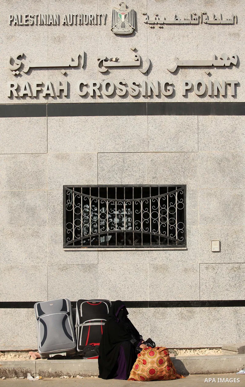 Palestinians gather at the Rafah border crossing in the southern Gaza Strip, as they await permission to enter Egypt on June 14, 2015. Egypt is due to reopen its Rafah border crossing with Gaza for three days. The Rafah...