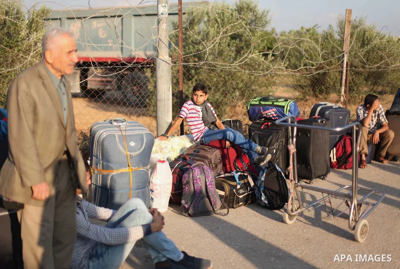 Palestinians gather at the Rafah border crossing in the southern Gaza Strip, as they await permission to enter Egypt on June 14, 2015. Egypt is due to reopen its Rafah border crossing with Gaza for three days. The Rafah...