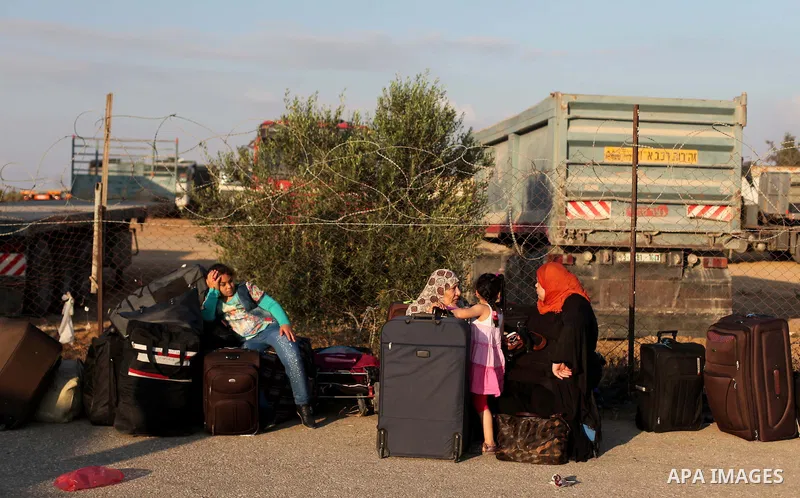 Palestinians gather at the Rafah border crossing in the southern Gaza Strip, as they await permission to enter Egypt on June 14, 2015. Egypt is due to reopen its Rafah border crossing with Gaza for three days. The Rafah...