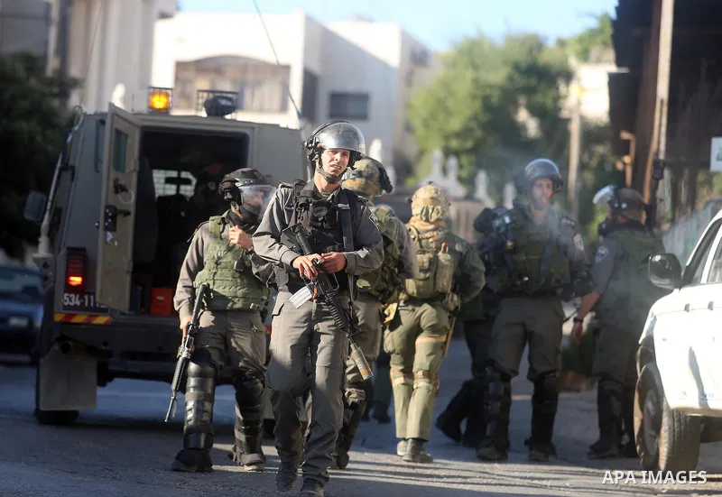 Israeli soldiers take position during confrontations with Palestinians in the village of Kafr Malik, northeast of Ramallah on June 14, 2015, after clashes that resulted in the death of 21-year-old Palestinian Abdallah Gh...