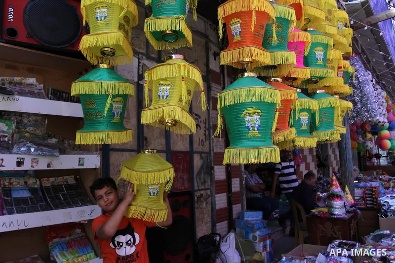 A Palestinian boy carries a traditional Ramadan lantern known as "Fanous" at a market, ahead of the holy fasting month of Ramadan in Khan Younis in the southern Gaza Strip, June 14, 2015. Photo by Abed Rahim Khatib