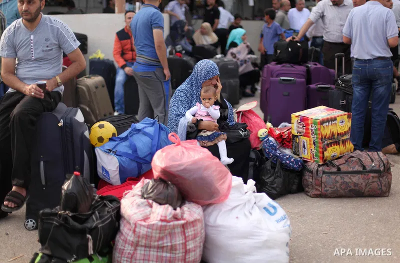Palestinians wait for travel permits to cross into Egypt at the Rafah border crossing between Egypt and southern Gaza Strip June 15, 2015. Egypt opened the Rafah border crossing on Saturday to allow Palestinians to trave...
