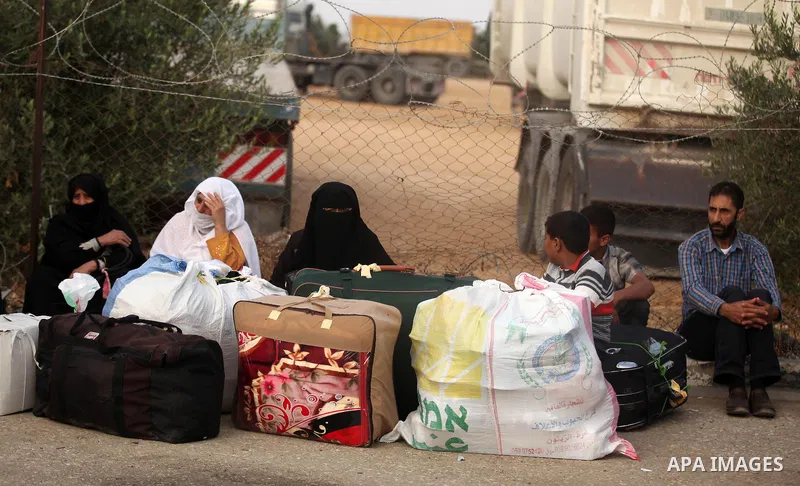 Palestinians wait for travel permits to cross into Egypt at the Rafah border crossing between Egypt and southern Gaza Strip June 15, 2015. Egypt opened the Rafah border crossing on Saturday to allow Palestinians to trave...