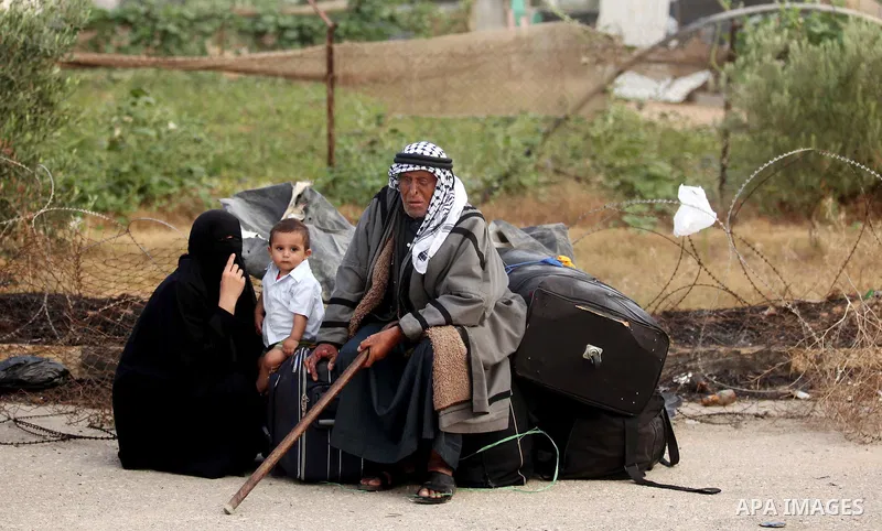Palestinians wait for travel permits to cross into Egypt at the Rafah border crossing between Egypt and southern Gaza Strip June 15, 2015. Egypt opened the Rafah border crossing on Saturday to allow Palestinians to trave...