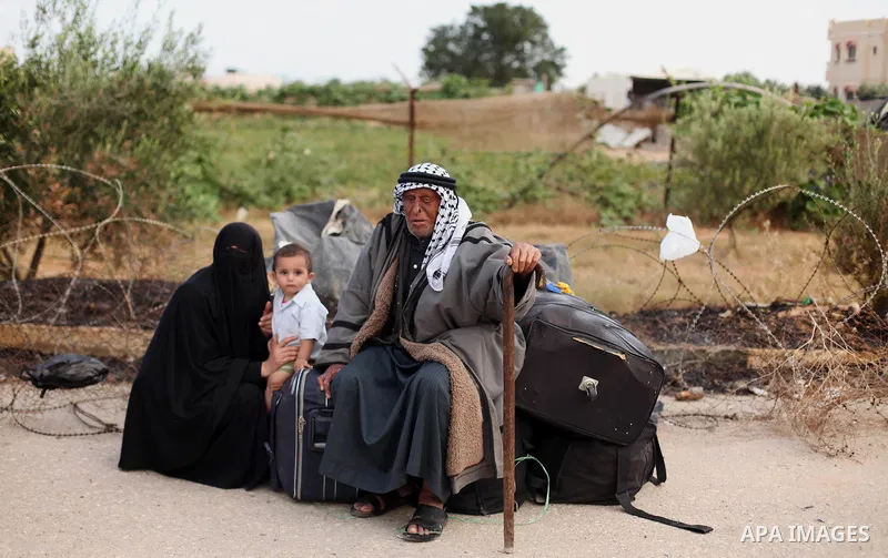 Palestinians wait for travel permits to cross into Egypt at the Rafah border crossing between Egypt and southern Gaza Strip June 15, 2015. Egypt opened the Rafah border crossing on Saturday to allow Palestinians to trave...