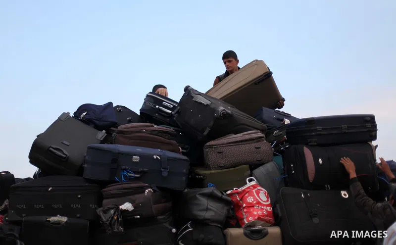 Palestinians wait for travel permits to cross into Egypt at the Rafah border crossing between Egypt and southern Gaza Strip June 15, 2015. Egypt opened the Rafah border crossing on Saturday to allow Palestinians to trave...