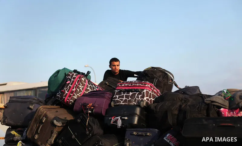 Palestinians wait for travel permits to cross into Egypt at the Rafah border crossing between Egypt and southern Gaza Strip June 15, 2015. Egypt opened the Rafah border crossing on Saturday to allow Palestinians to trave...