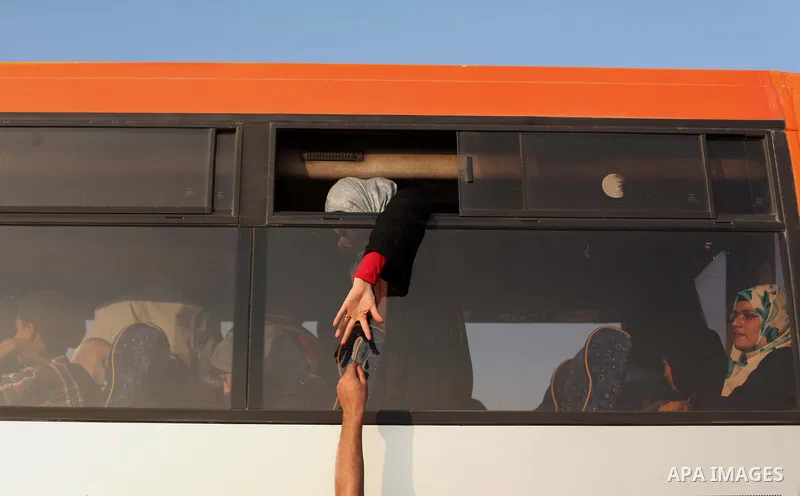 Palestinians wait for travel permits to cross into Egypt at the Rafah border crossing between Egypt and southern Gaza Strip June 15, 2015. Egypt opened the Rafah border crossing on Saturday to allow Palestinians to trave...