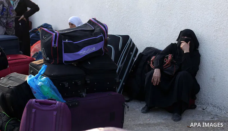 Palestinians wait for travel permits to cross into Egypt at the Rafah border crossing between Egypt and southern Gaza Strip June 15, 2015. Egypt opened the Rafah border crossing on Saturday to allow Palestinians to trave...