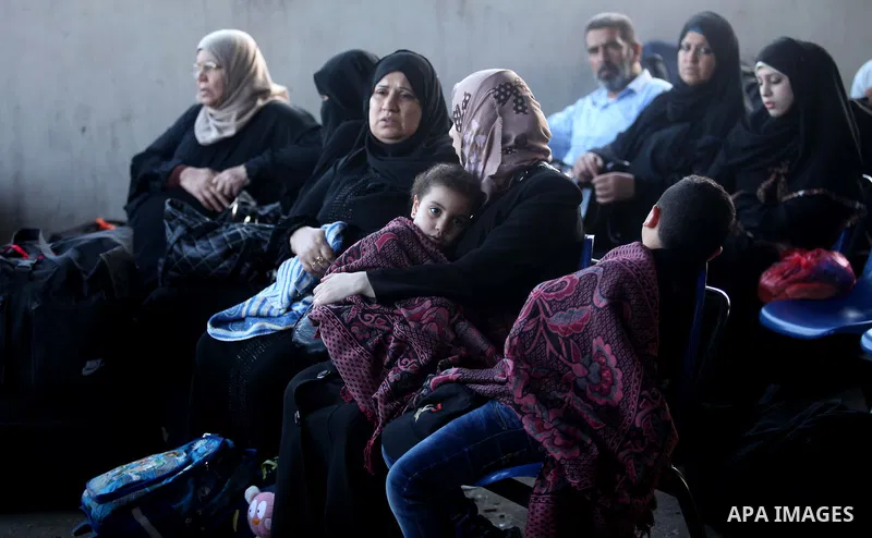 Palestinians wait for travel permits to cross into Egypt at the Rafah border crossing between Egypt and southern Gaza Strip June 15, 2015. Egypt opened the Rafah border crossing on Saturday to allow Palestinians to trave...