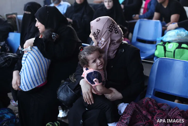 Palestinians wait for travel permits to cross into Egypt at the Rafah border crossing between Egypt and southern Gaza Strip June 15, 2015. Egypt opened the Rafah border crossing on Saturday to allow Palestinians to trave...