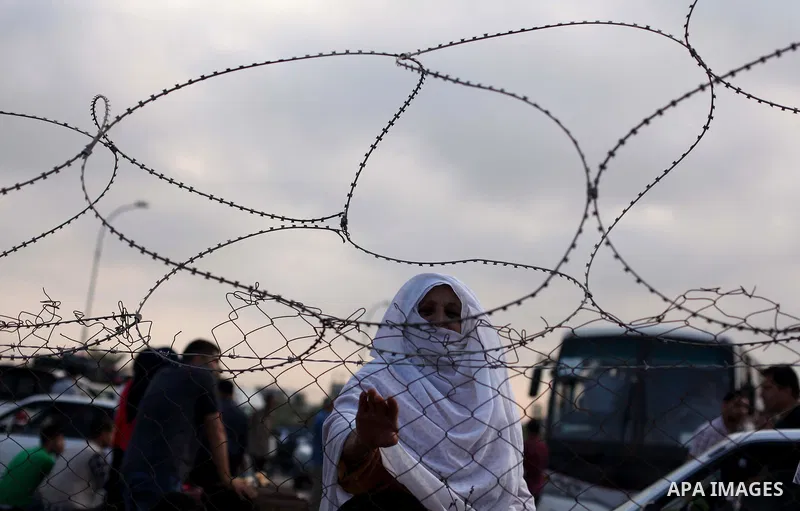 Palestinians wait for travel permits to cross into Egypt at the Rafah border crossing between Egypt and southern Gaza Strip June 15, 2015. Egypt opened the Rafah border crossing on Saturday to allow Palestinians to trave...