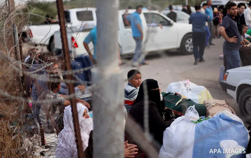 Palestinians wait for travel permits to cross into Egypt at the Rafah border crossing between Egypt and southern Gaza Strip June 15, 2015. Egypt opened the Rafah border crossing on Saturday to allow Palestinians to trave...
