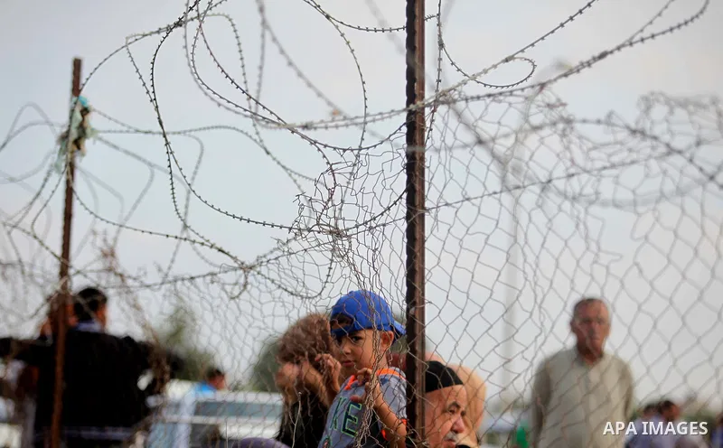 Palestinians wait for travel permits to cross into Egypt at the Rafah border crossing between Egypt and southern Gaza Strip June 15, 2015. Egypt opened the Rafah border crossing on Saturday to allow Palestinians to trave...