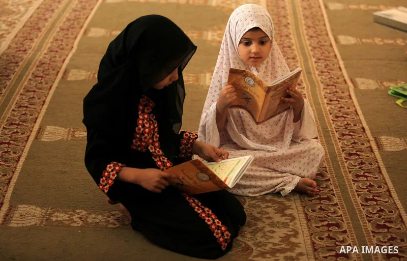 Palestinian girls read verses from the Quran during a class on how to read Islam's holy book, at Dar Al Ketab and sunna in Gaza city, on June 15, 2015. A summer camp in the Gaza Strip, Dar Al Ketab and sunna, plans to te...