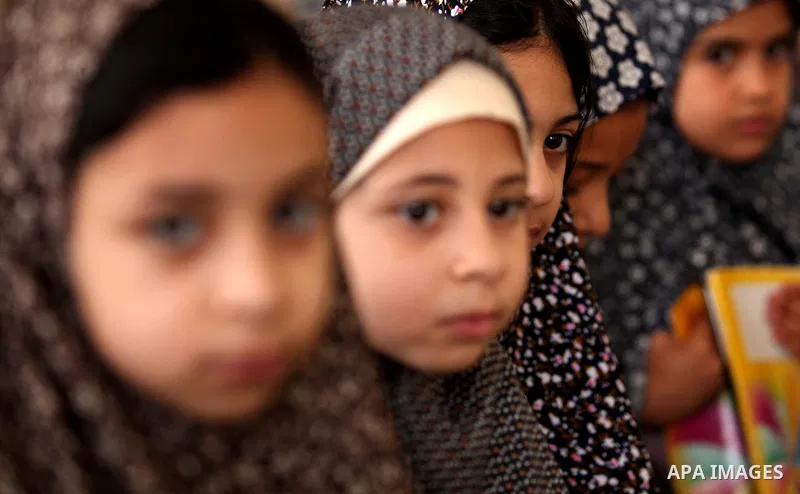 Palestinian girls read verses from the Quran during a class on how to read Islam's holy book, at Dar Al Ketab and sunna in Gaza city, on June 15, 2015. A summer camp in the Gaza Strip, Dar Al Ketab and sunna, plans to te...