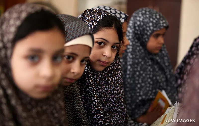 Palestinian girls read verses from the Quran during a class on how to read Islam's holy book, at Dar Al Ketab and sunna in Gaza city, on June 15, 2015. A summer camp in the Gaza Strip, Dar Al Ketab and sunna, plans to te...