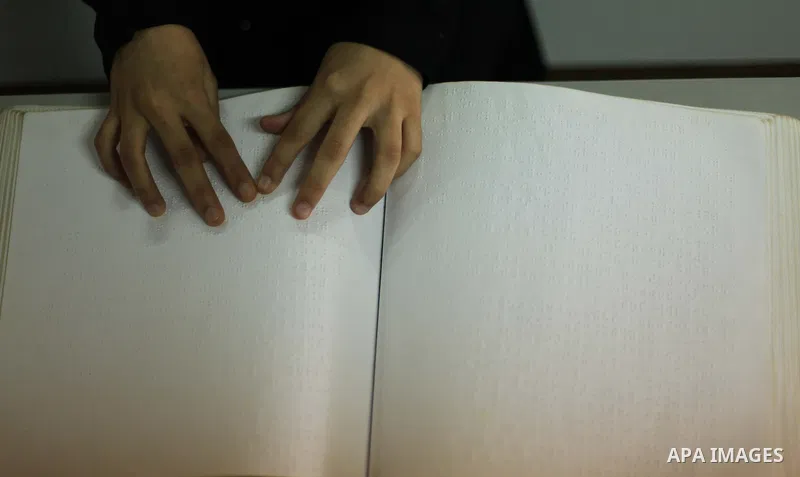 A Palestinian blind girl reads and memorise the holy Quran in braille, at Dar Al Ketab and sunna in Gaza city, on June 15, 2015. A summer camp in the Gaza Strip, Dar Al Ketab and sunna, plans to teach students the Holy Q...