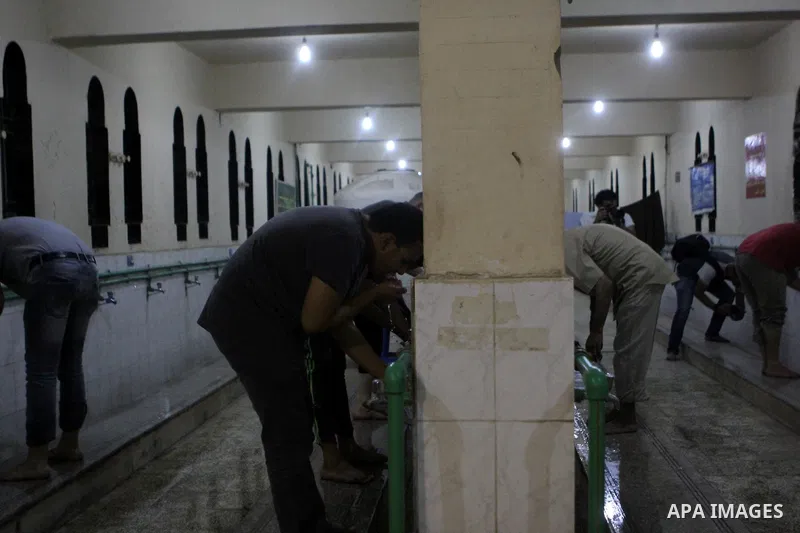 Egyptian worshipers perform ablution before an evening prayer "Taraweeh", at Amr Ibn al-Aas mosque, in Cairo on June 17, 2015. Millions of Muslims around the world will mark the start of Ramadan on Thursday June 18, a mo...