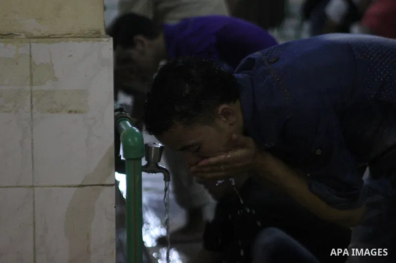 Egyptian worshipers perform ablution before an evening prayer "Taraweeh", at Amr Ibn al-Aas mosque, in Cairo on June 17, 2015. Millions of Muslims around the world will mark the start of Ramadan on Thursday June 18, a mo...