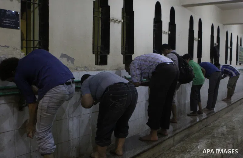 Egyptian worshipers perform ablution before an evening prayer "Taraweeh", at Amr Ibn al-Aas mosque, in Cairo on June 17, 2015. Millions of Muslims around the world will mark the start of Ramadan on Thursday June 18, a mo...