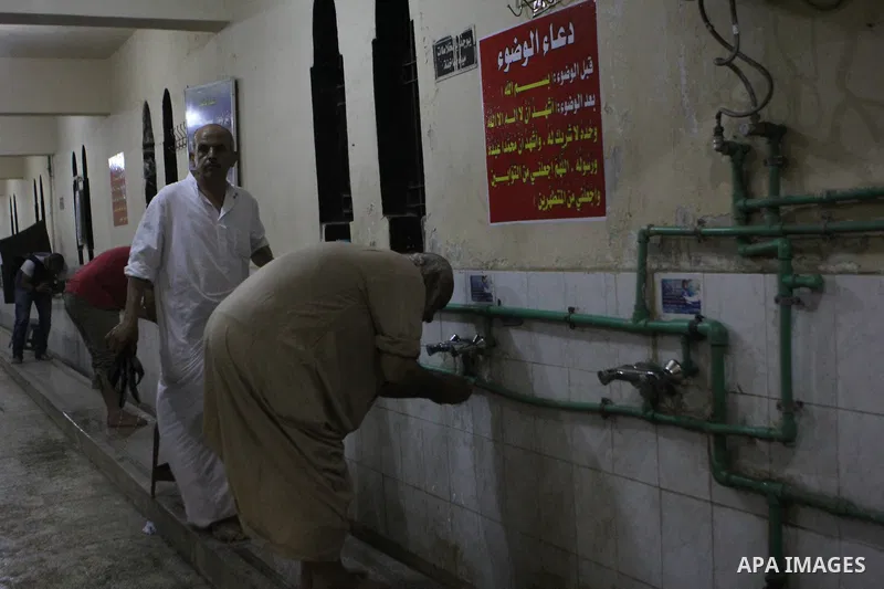 Egyptian worshipers perform ablution before an evening prayer "Taraweeh", at Amr Ibn al-Aas mosque, in Cairo on June 17, 2015. Millions of Muslims around the world will mark the start of Ramadan on Thursday June 18, a mo...