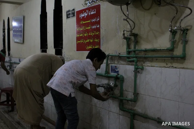 Egyptian worshipers perform ablution before an evening prayer "Taraweeh", at Amr Ibn al-Aas mosque, in Cairo on June 17, 2015. Millions of Muslims around the world will mark the start of Ramadan on Thursday June 18, a mo...