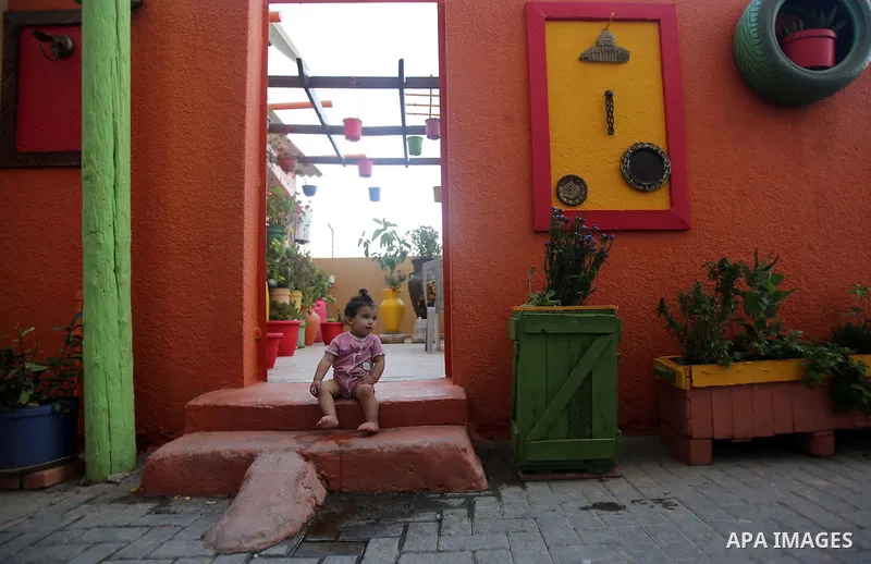 A photo taken on June 17, 2015 shows colored houses in the old city of Gaza, as Palestinians colored the walls of houses in the area to prepare for the start of the Muslim holy fasting month of Ramadan. More than 1.5 bil...