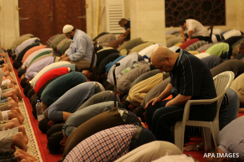 Palestinian worshipers perform take part in an evening prayer "Taraweeh", at El Khalidi mosque, in Gaza city, on June 17, 2015. Millions of Muslims around the world will mark the start of Ramadan on Thursday June 18, a m...