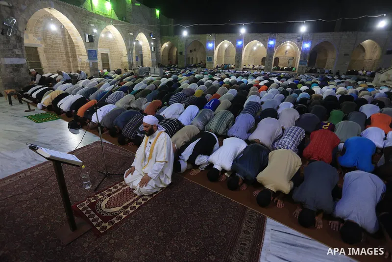 Palestinian worshipers perform 'taraweeh', nightly prayer of the month of Ramadan at Omari mosque, in Gaza city on June 18, 2015. During Ramadan, Muslim believers abstain from eating, drinking, smoking and having sex fro...