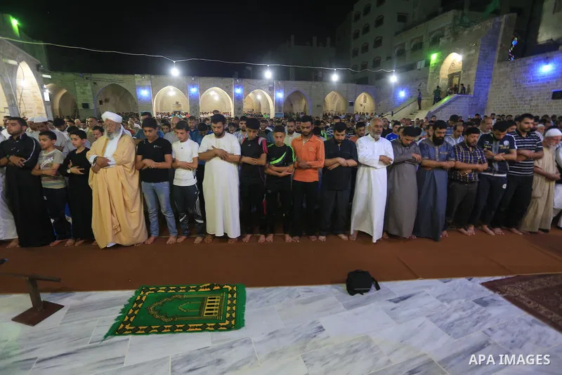 Palestinian worshipers perform 'taraweeh', nightly prayer of the month of Ramadan at Omari mosque, in Gaza city on June 18, 2015. During Ramadan, Muslim believers abstain from eating, drinking, smoking and having sex fro...