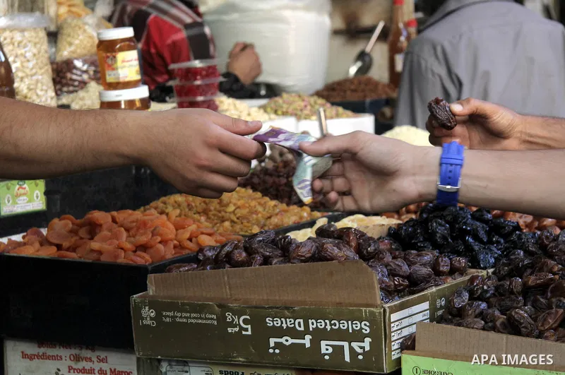 A Palestinian vendor dates at his shop on the first day of the holy month of Ramadan, in Gaza city on June 18, 2015. During Ramadan, Muslim believers abstain from eating, drinking, smoking and having sex from dawn until...
