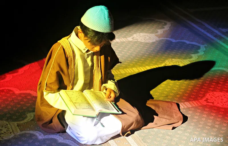 A Palestinian boy reads Quran at a mosque on the first day of the holy month of Ramadan, in Gaza city on June 18, 2015. During Ramadan, Muslim believers abstain from eating, drinking, smoking and having sex from dawn unt...
