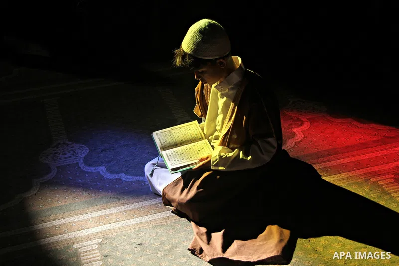 A Palestinian boy reads Quran at a mosque on the first day of the holy month of Ramadan, in Gaza city on June 18, 2015. During Ramadan, Muslim believers abstain from eating, drinking, smoking and having sex from dawn unt...