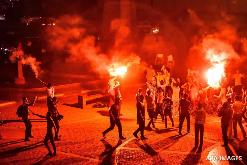 Members of Ultras Nahdawy group, who are supporters of the Muslim Brotherhood and ousted President Mohamed Morsi, light flares and shout slogans during a demonstration against military rule at Abdel Moneim Riad Square in...