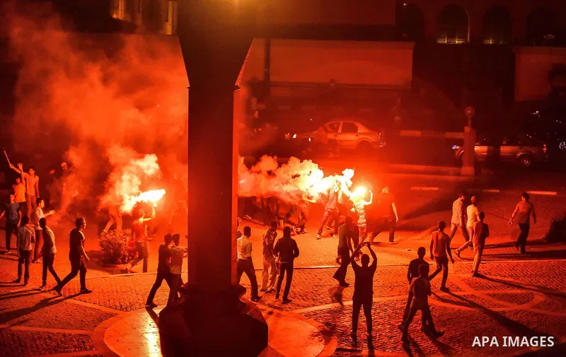 Members of Ultras Nahdawy group, who are supporters of the Muslim Brotherhood and ousted President Mohamed Morsi, light flares and shout slogans during a demonstration against military rule at Abdel Moneim Riad Square in...