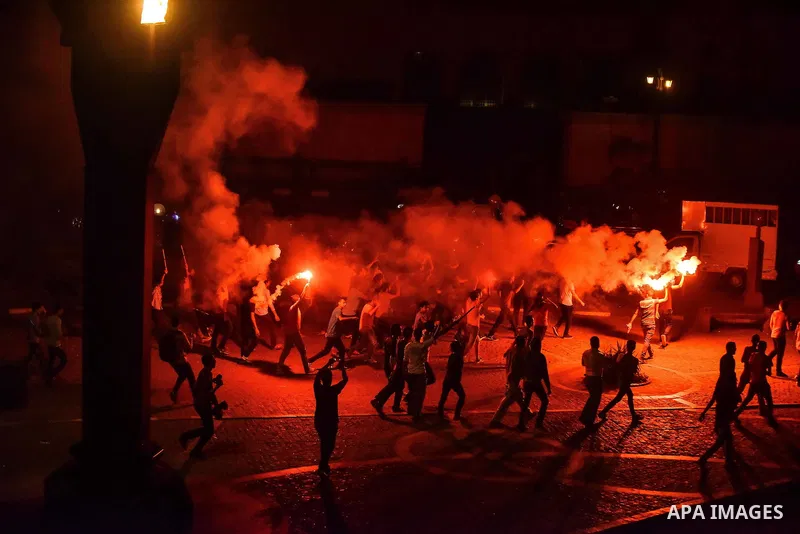 Members of Ultras Nahdawy group, who are supporters of the Muslim Brotherhood and ousted President Mohamed Morsi, light flares and shout slogans during a demonstration against military rule at Abdel Moneim Riad Square in...