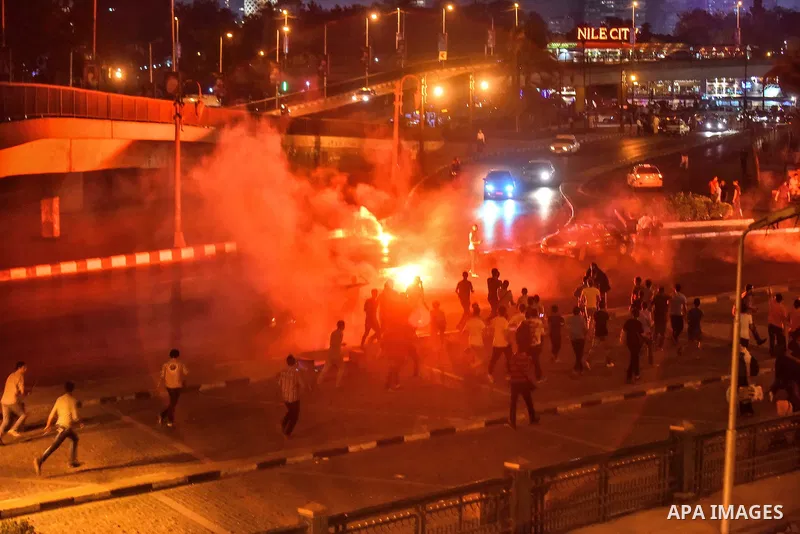 Members of Ultras Nahdawy group, who are supporters of the Muslim Brotherhood and ousted President Mohamed Morsi, light flares and shout slogans during a demonstration against military rule at Abdel Moneim Riad Square in...