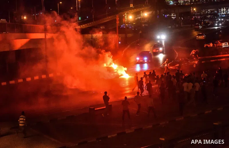 Members of Ultras Nahdawy group, who are supporters of the Muslim Brotherhood and ousted President Mohamed Morsi, light flares and shout slogans during a demonstration against military rule at Abdel Moneim Riad Square in...